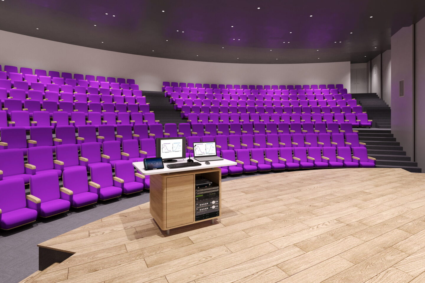 A large auditorium with many purple seats, at its center a podium with Kramer AV products installed