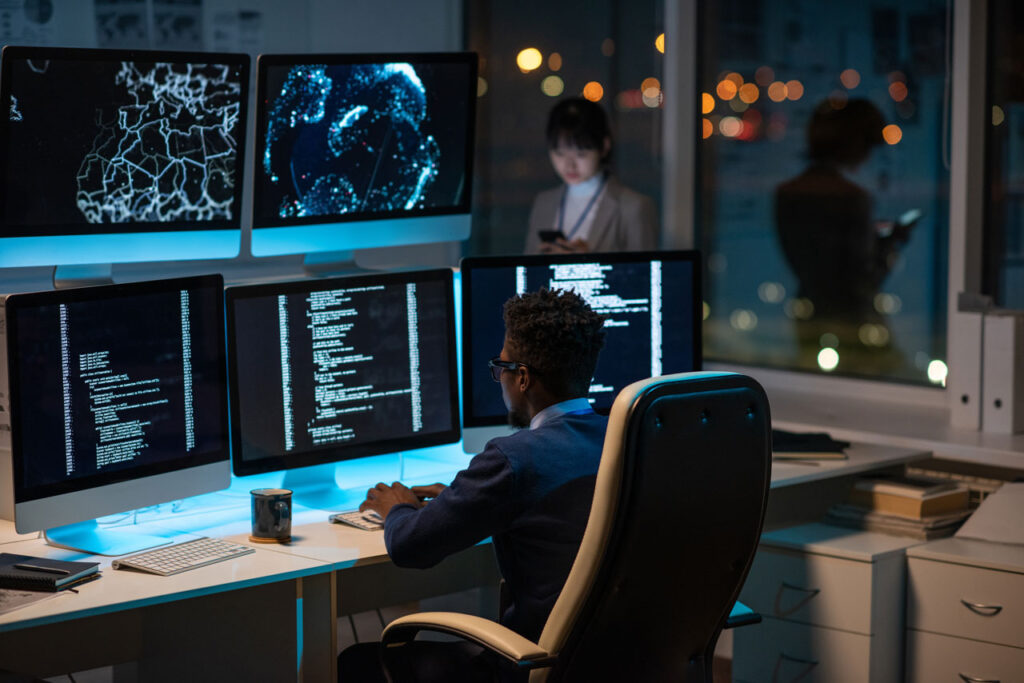 A man looking at computer screens, using Kramer AV control system