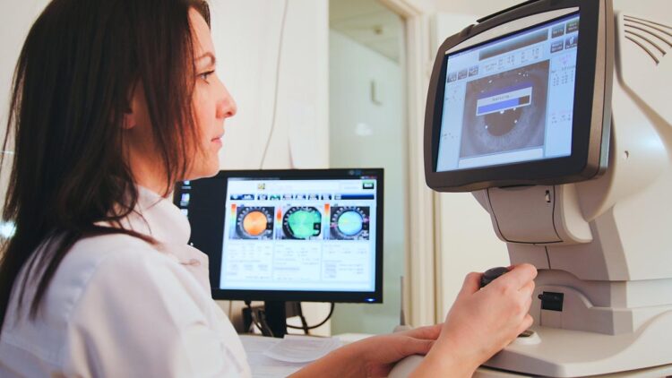 An ophthalmologist looking at the screen, utilizing Kramer's AV solutions for Healthcare