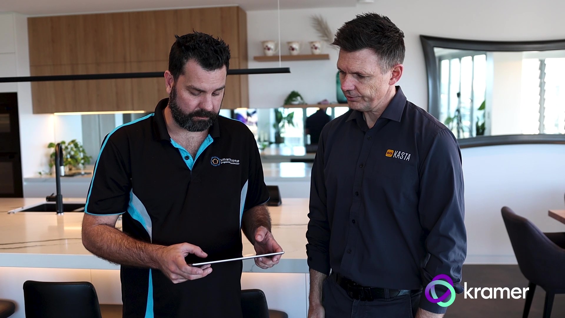 Two technicians of KASTA Technologies, AU, discussing Kramer's Smart Home Control solution