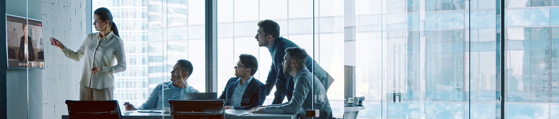 People sitting in a hybrid meeting room, using Kramer and Yealink joint solutions