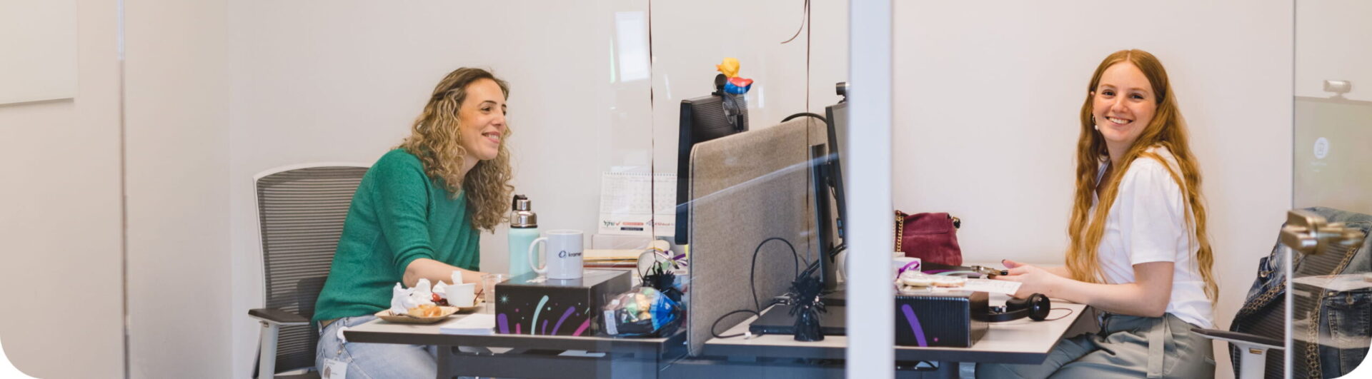 Two Kramer employees, working at the office, smiling at the camera