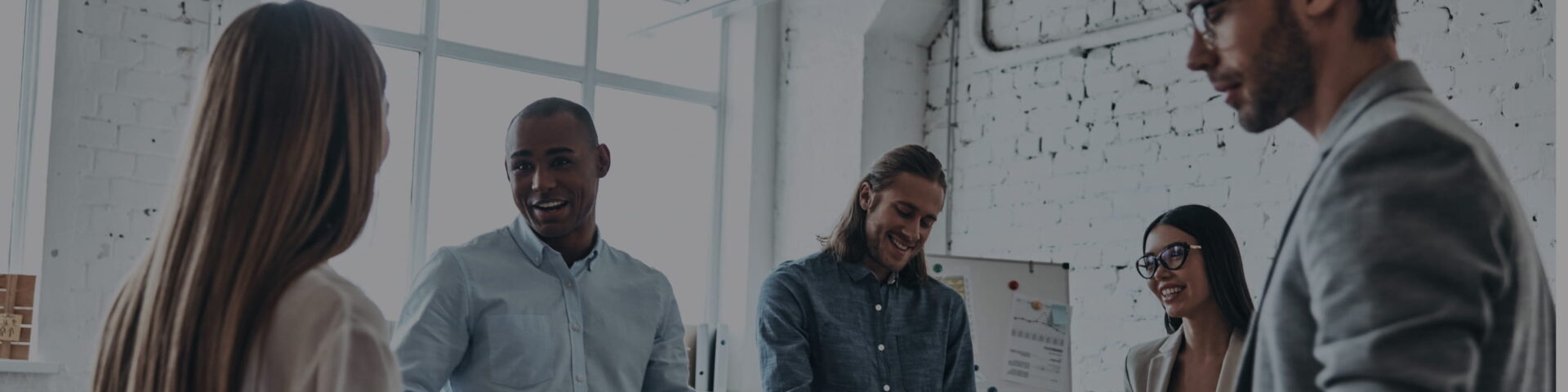 People standing in an office, laughing