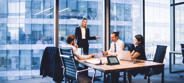 People meeting at a huddle room, where Kramer's solutions are installed