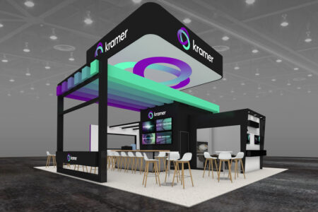 Kramer's booth at InfoComm 2023 - a booth colored in black, green and purple