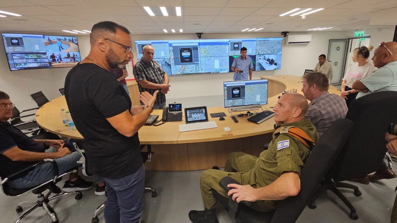 People talking at Ramat Gan municipality's command & control room, in which Kramer's Control and AVoIP solutions are installed