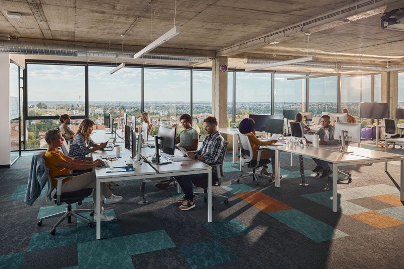 People in an office space, during a hybrid meeting