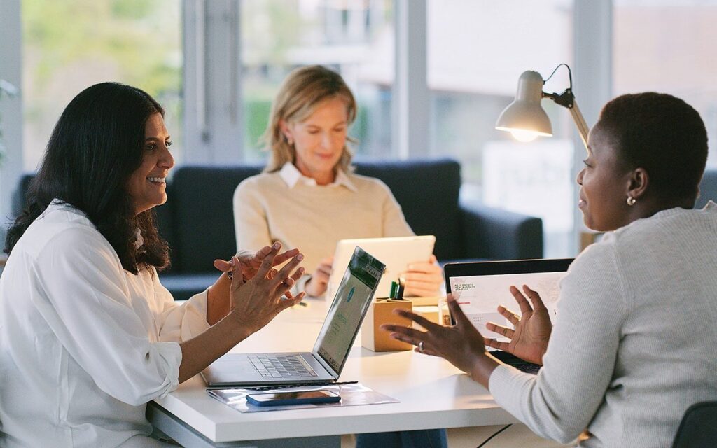Three people during a meeting, talking to each other
