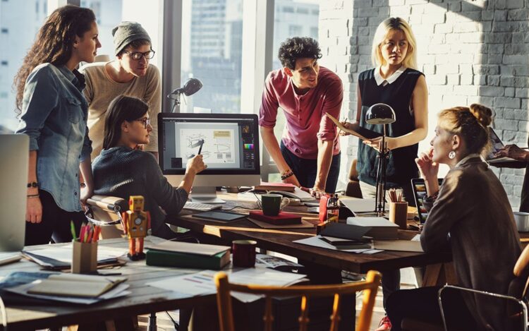 A group of people during a meeting, talking to each other