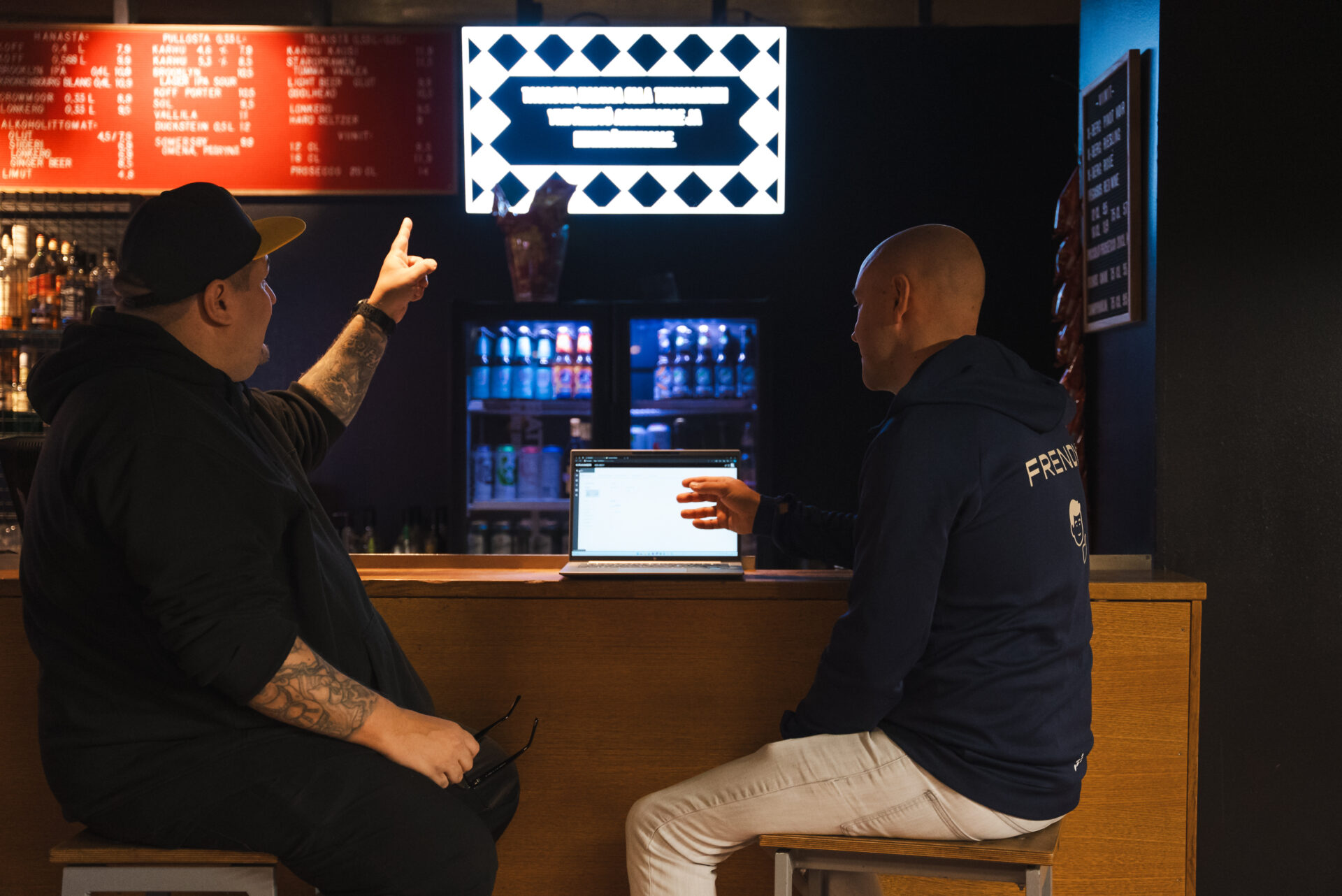 Tavastia Live Club, two people sitting next to the displays powered by Kramer's AVoIP
